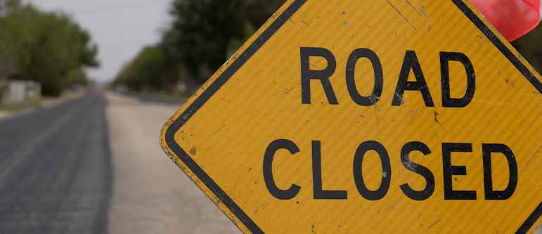 Road with street sign in the way saying Road Closed